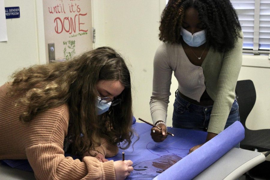 During lunch on Feb. 2, seniors Frankie Witt and Gabrielle Lashley make a poster in honor of Black History Month during a Black Student Union club meeting.