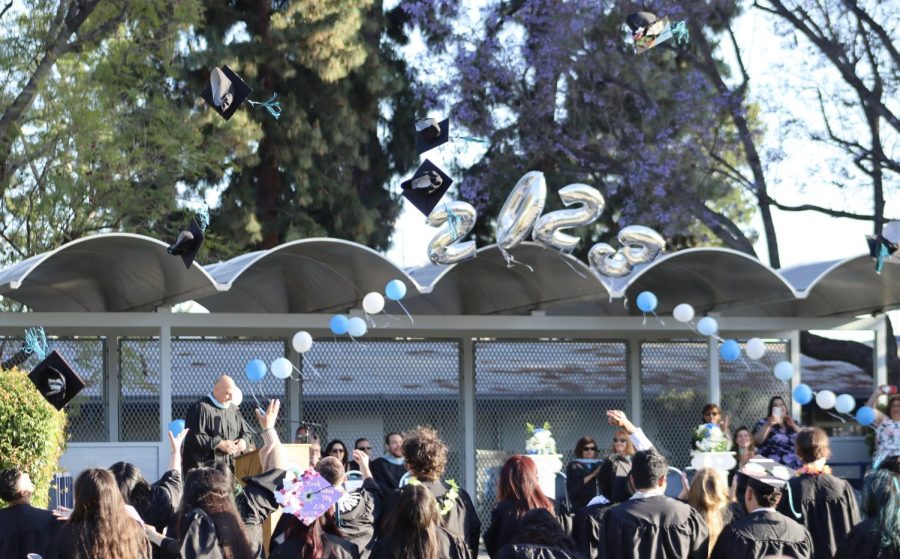 Graduates throw their caps in the air at the end of the graduation ceremony at Mulholland Middle School on June 8. 