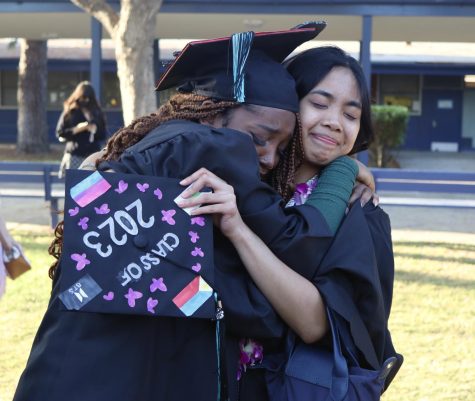 Seniors Gabrielle Lashley and Jenica Felicitas hug each other after the Class of 2023 graduation cermony on June 8.