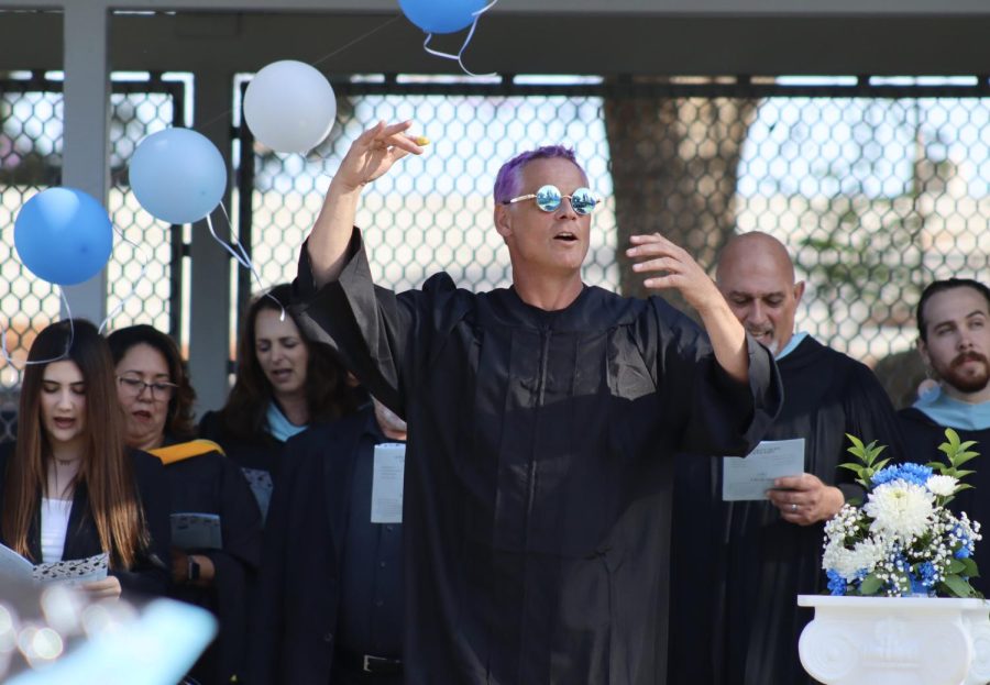 Music teacher Wes Hambright leads the graduates and attendees in an acapella version of the Star Spangled Banner during the graduation ceremony on June 8. 