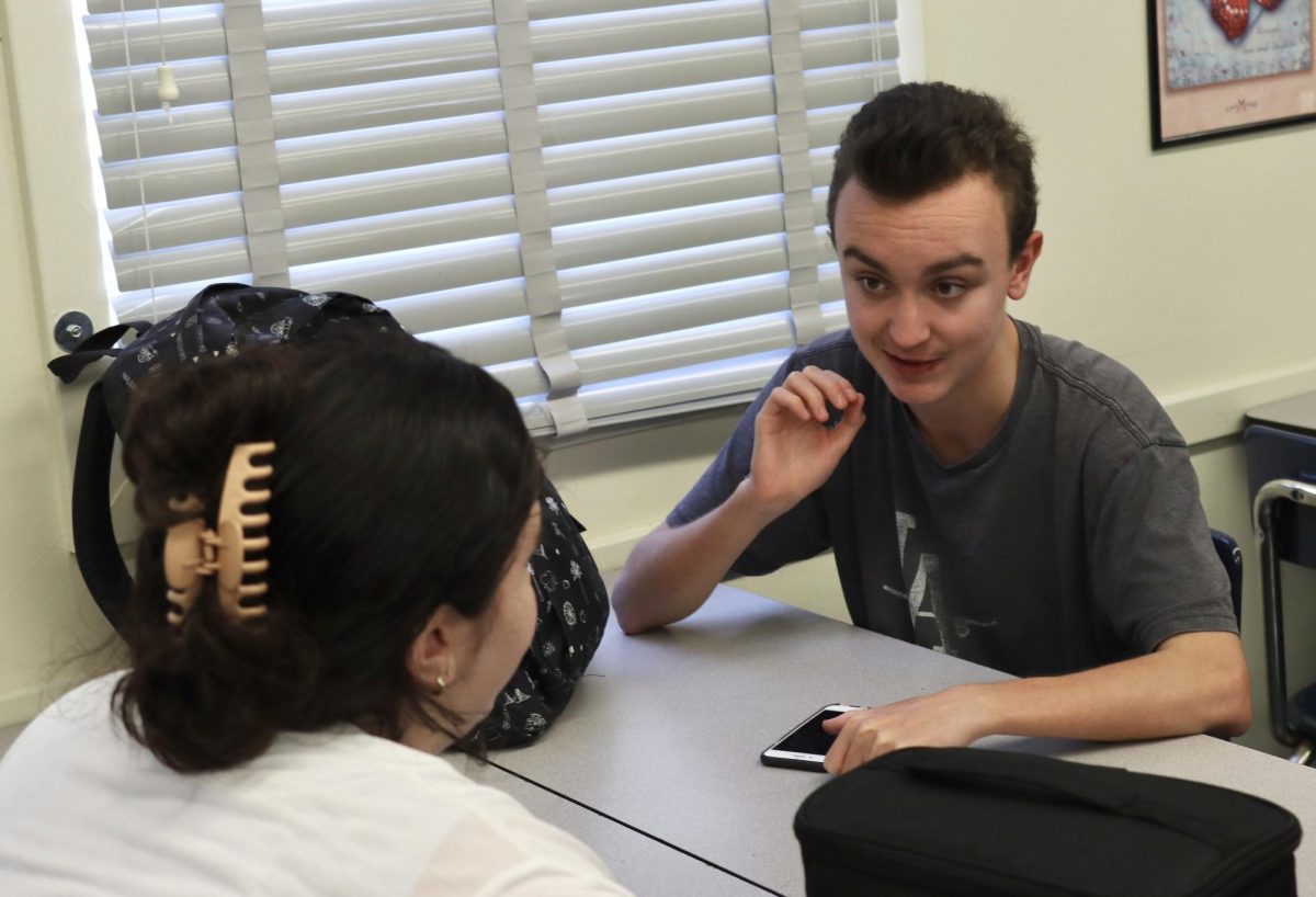 Senior Riley Salz talks to a Daniel Pearl Magnet High School faculty member during lunch on Aug. 14. 