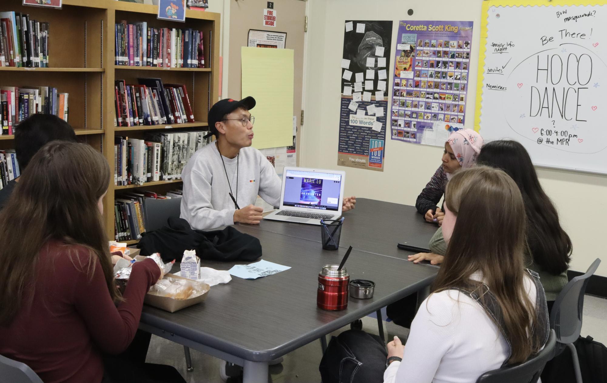 Librarian Alain Cruz talks with members of Book Club during a lunch meeting in the library on Sept. 21. 
