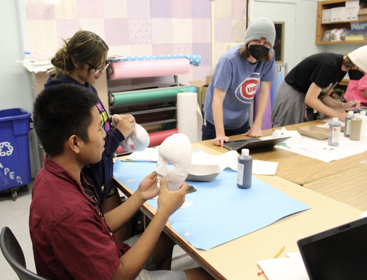 Senior David Antonio prepares to paint a mask with an ancient African empire-based design on Sept. 6 in AP
African American Studies The course is a new AP class in its first year at the school.