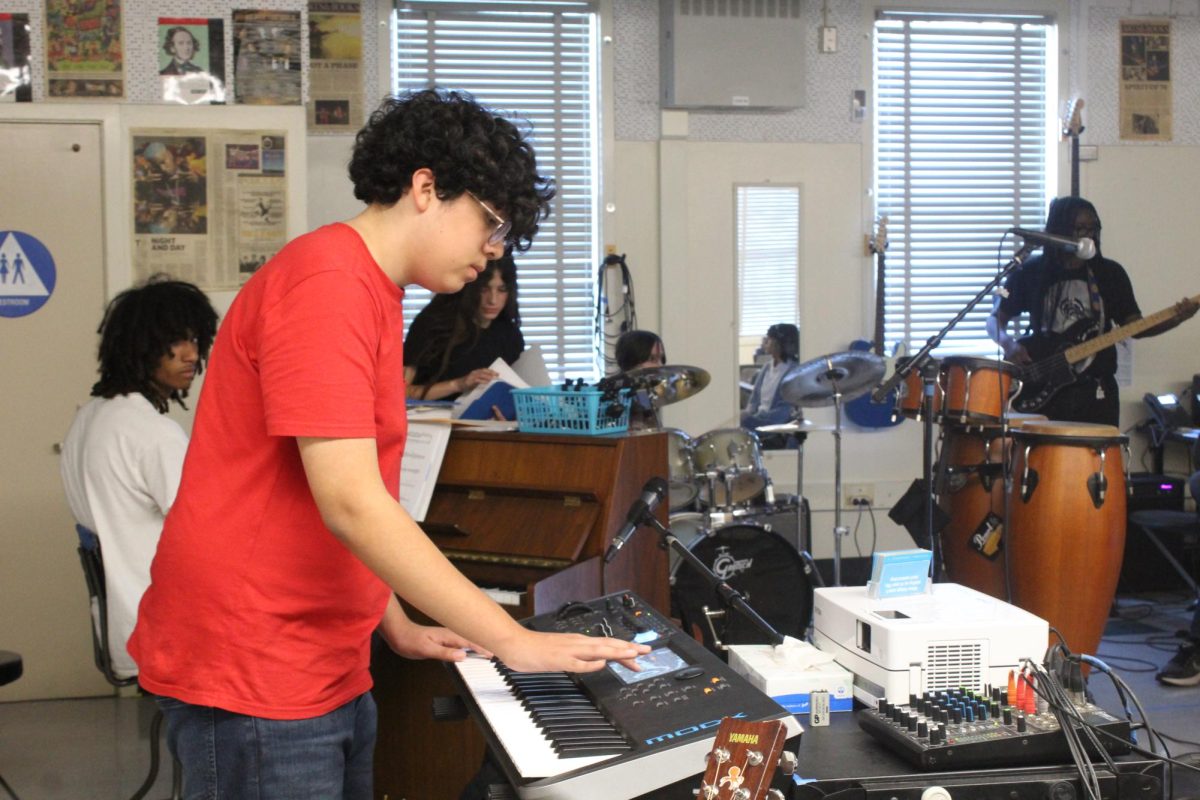 Junior Ben Recinos practices the synth during a World Music Day rehearsal on Oct. 17.