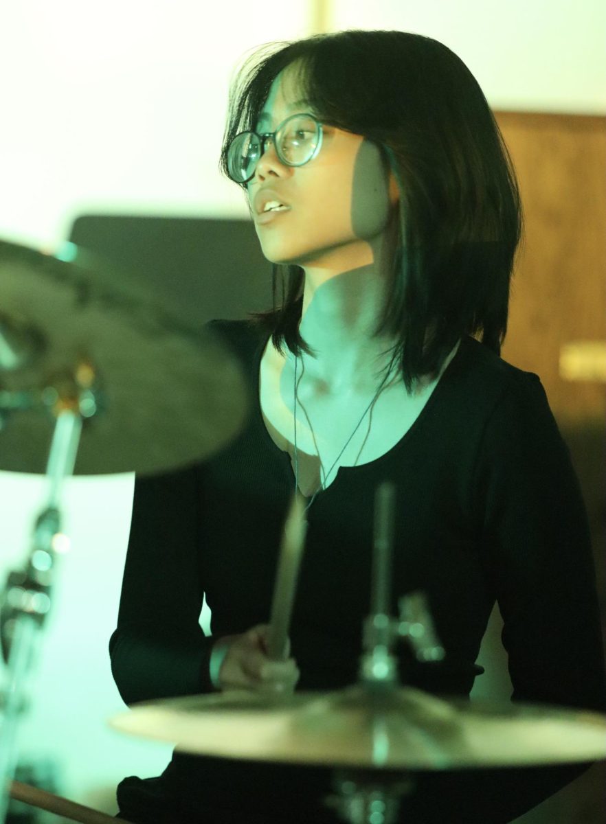 Senior Rikka Dimalanta plays the drums for a performance of Brazil by Declan McKenna during World Music Day on Oct. 25.