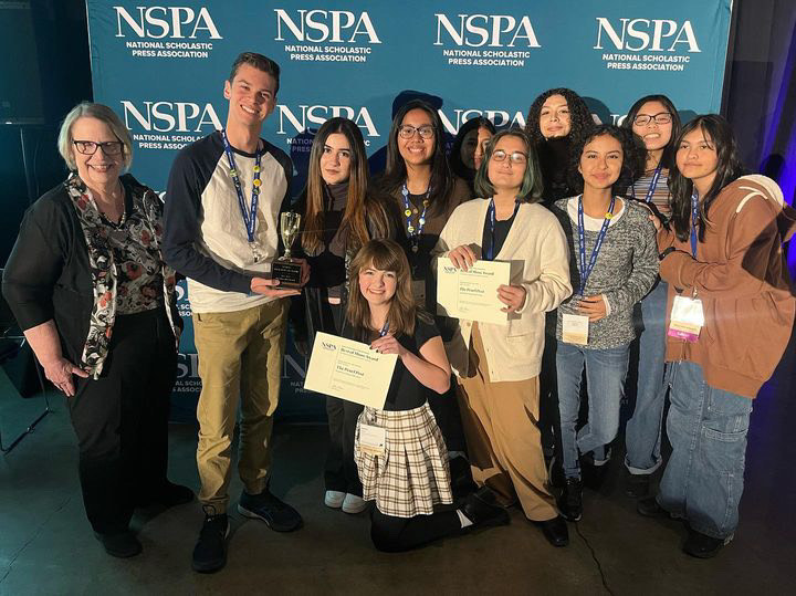 The Pearl Post staff holds the publications Best of Show awards during the National Scholastic Press Association awards ceremony on Nov. 4.