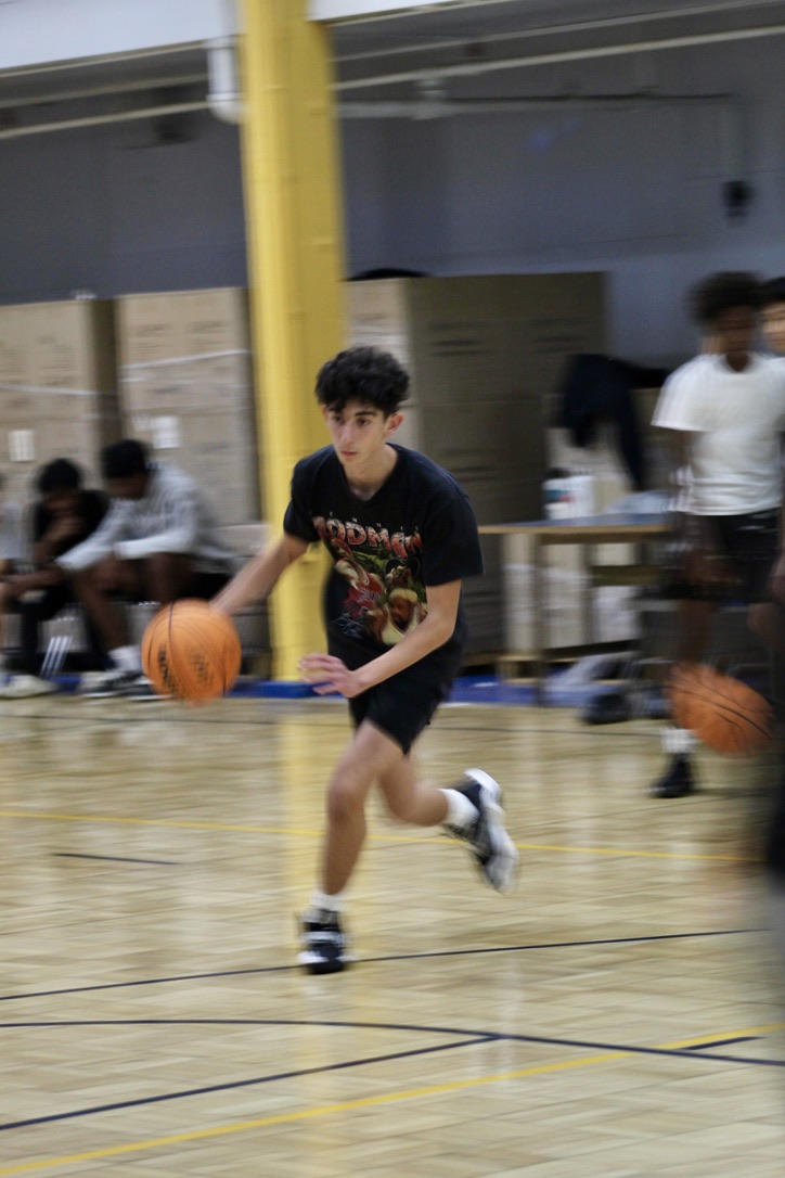 Sophomore Maor Segalovich dribbles the ball across the court during basketball practice at Birmingham Community Charter High School on Nov. 29. 
