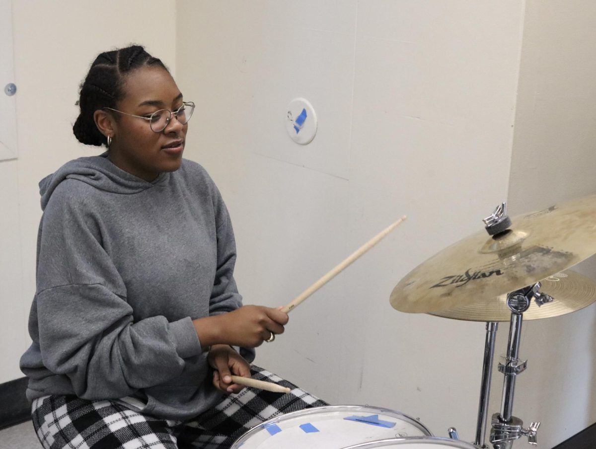 Senior Madyson Phillips plays drums during an after-school rehearsal on Dec. 4.