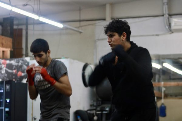 Freshmen David Grigorian and Hovhannes Barseghyan throw air punches during warmups for boxing practice on Dec. 2. Shadow boxing helps them work on their footwork, technique and form without having to focus on hitting a target. 