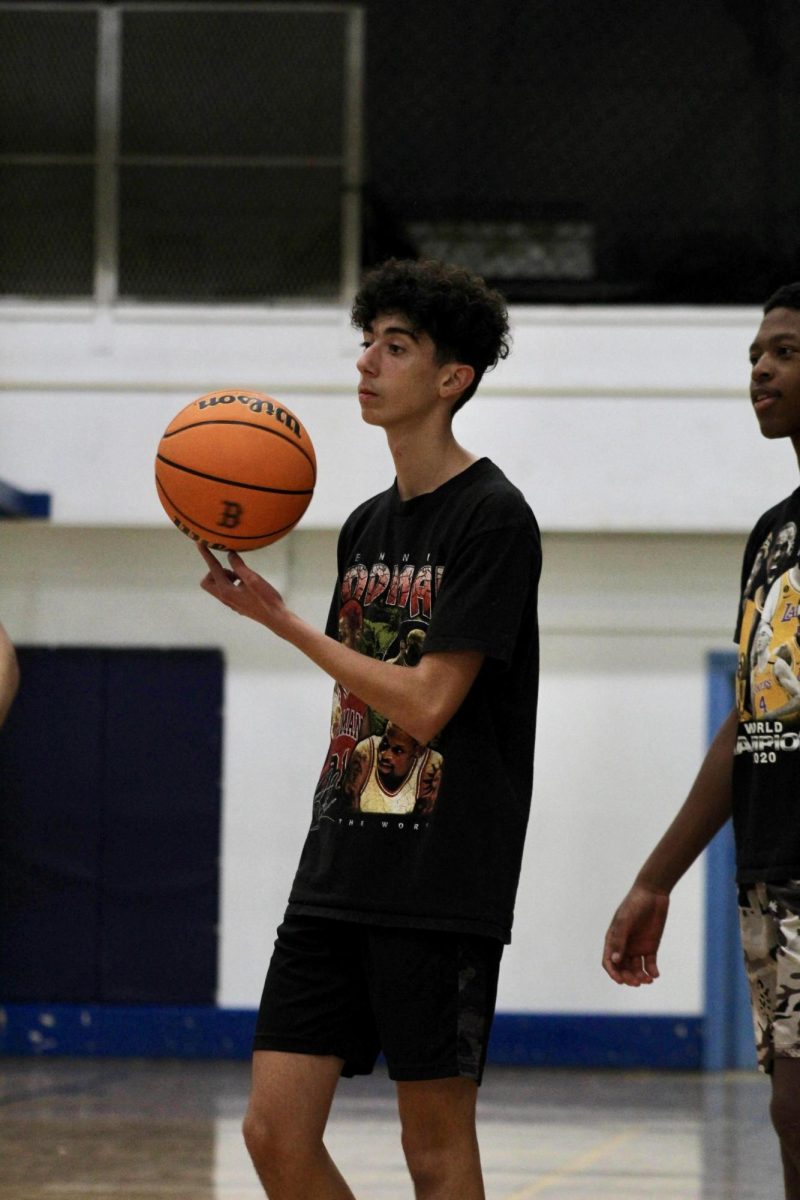 Sophomore Maor Segalovich spins a basketball as he waits his turn to shoot the ball during basketball practice at Birmingham Community Charter High School on Nov. 29. Segalovich is on the boys JV basketball team. 