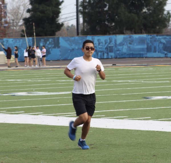 Freshman Daniel Salazar runs around the track during track and field practice at Birmingham Community Charter High School on Jan. 18. During the off-season, Salazar remains consistent by dedicating time to training at the Rose Bowl.