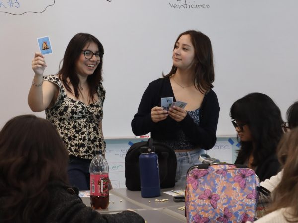 Hispanic Club President Sara Gomez and Vice President Alejandra Iniguez call out cards during a game of Lotería played at a club meeting on Jan. 25. Lotería, which is similar to the game Bingo, originated in Italy and is a well-known game in Mexico. 