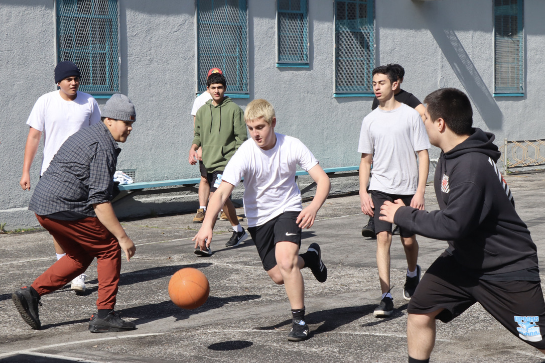 Freshman Haskell Fay plays basketball with his classmates during their period 3 P.E. class on Feb. 8.