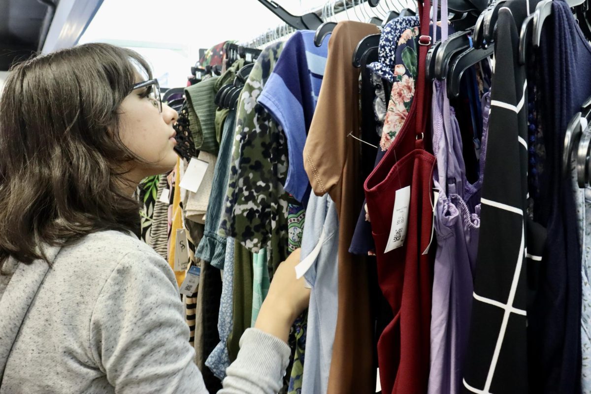 Junior Alia Galvan browses through some clothes at Goodwill, a thrift store in Tarzana. 