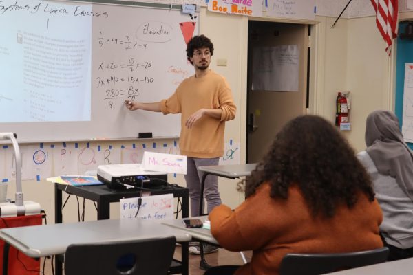 Math teacher Gonçalo Sousa tutors students on how to solve systems of equations on Jan. 31. Sousa is hosting after-school SAT tutoring sessions in his classroom to prepare juniors for the exam to be taken in March.