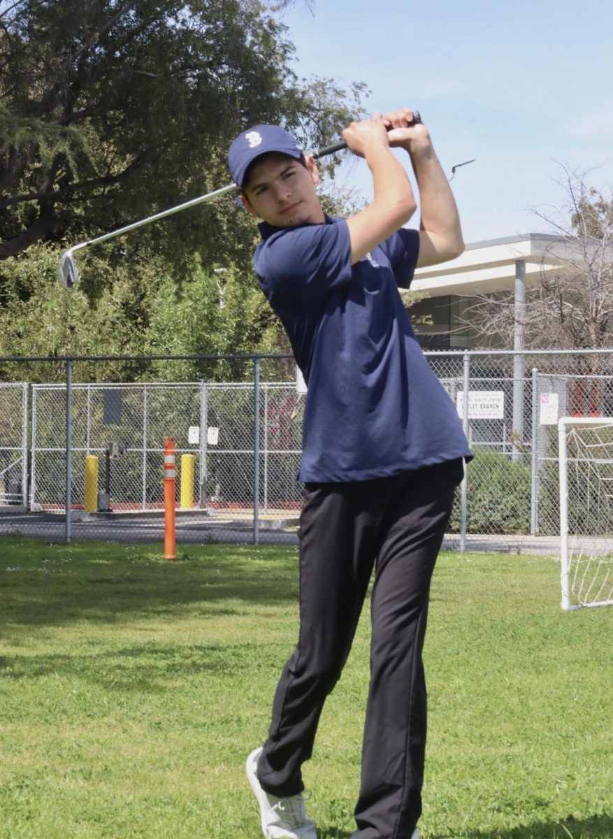 Freshman Mateo Zazueta perfects his swing in the front grove of Daniel Pearl Magnet High School on March 13. It is Zazuetas first year on the Birmingham Community Charter High School varsity golf team. 