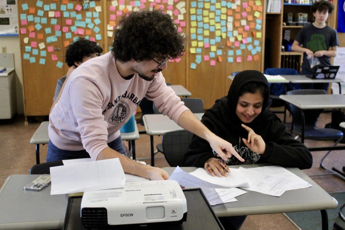 Math teacher Gonçalo Sousa helps junior Behishta Safi on April 11 during his weekly Thursday tutoring. During tutoring, Sousa provides students assistance and extra practice on Algebra 1 and 2, geometry and precalculus topics.