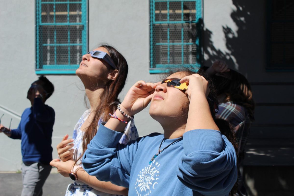 Freshmen in math teacher Tuan Duke Huynhs Algebra 1 class observe the April 8 solar eclipse during third period. Due to the danger the exposure to radiation caused by the eclipse, students had to wear special protective lenses. 