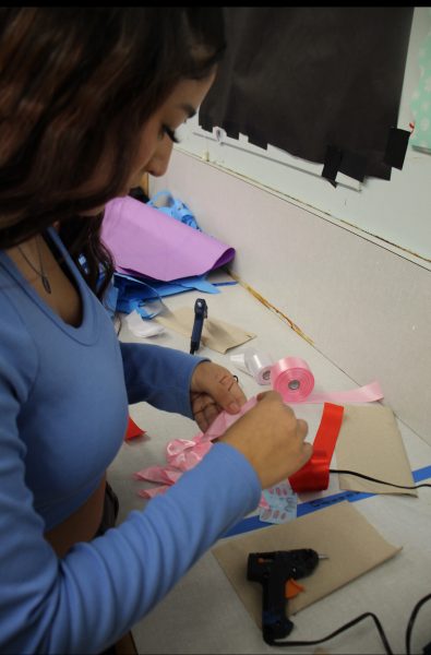 Senior Elizabeth Garcia practices making handmade ribbon rose bouquets for her bouquet-making business she started last spring. 