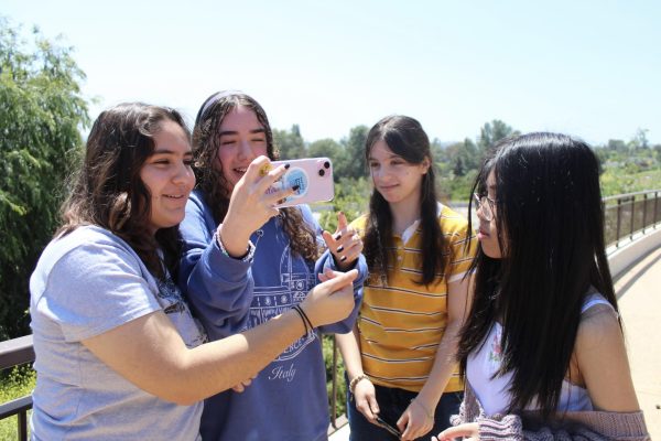 Freshmen Farrah Marquez, Desirae Carns, Lilia Manukyan, and Louise Gaguet take a selfie in front of a scenic view at Pierce College before seeing the play Shakespeare in Love on May 8.