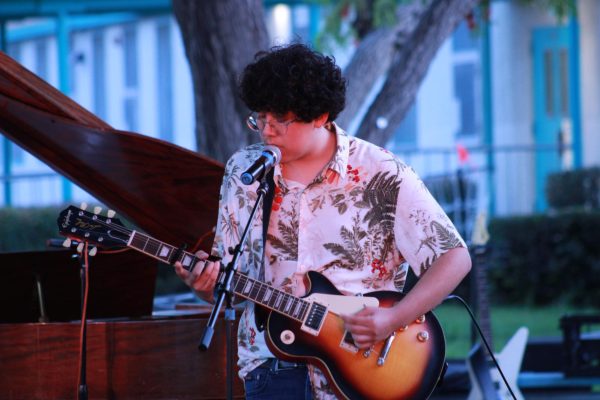 Junior Benjamin Recinos performs There Is a Light That Never Goes Out by The Smiths at the Spring Passion Concert in the grove on April 30.
