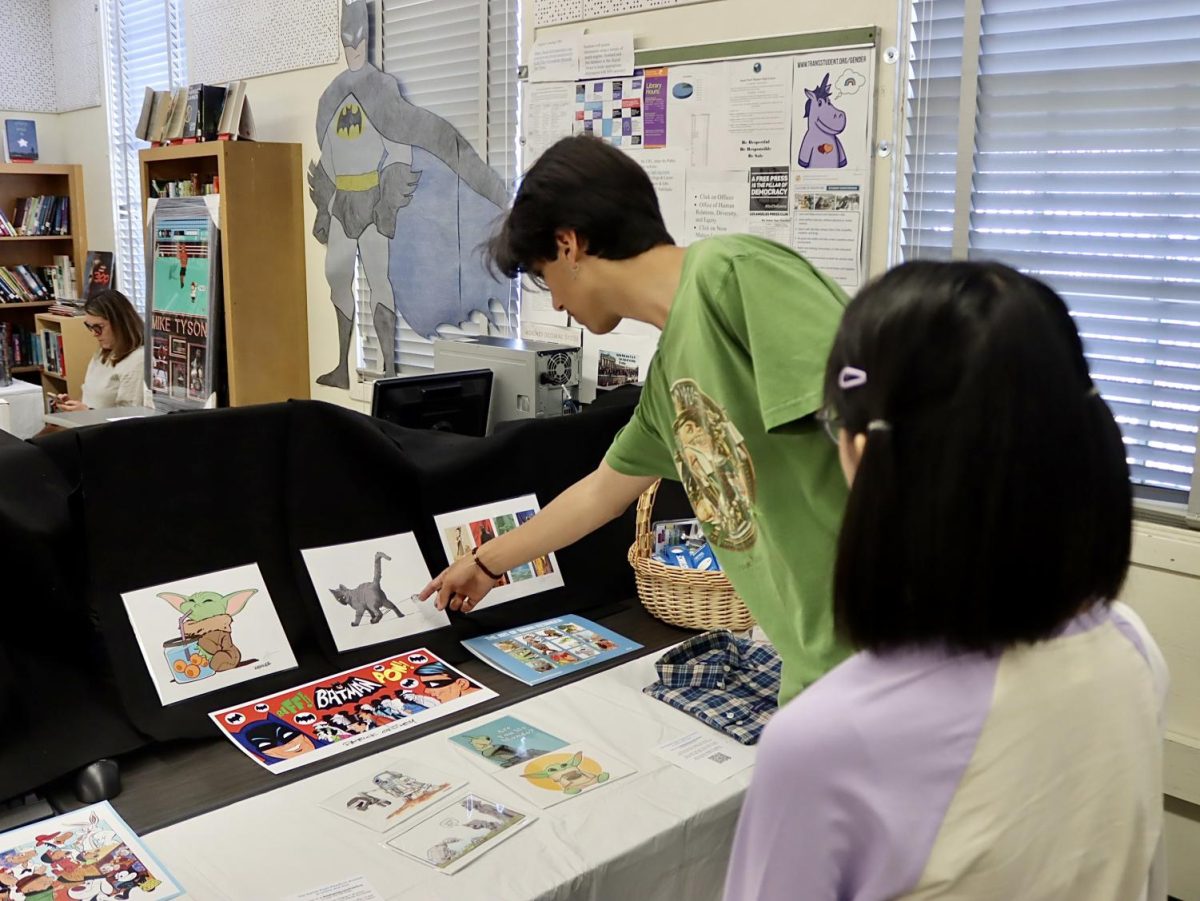 Sophomore Sebastian Olfatmanesh and junior Genesis Cuellar-Figueroa browse through an auction at last years PearlCon on May 13, 2023. PearlCon is held every year to bring the community together through auctions, games, performances and more.