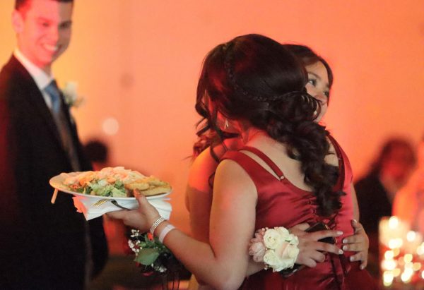 Junior Vanessa Gonzalez hugs senior Alejandra Iniquez during prom at the Orchard Conference Center on April 27.