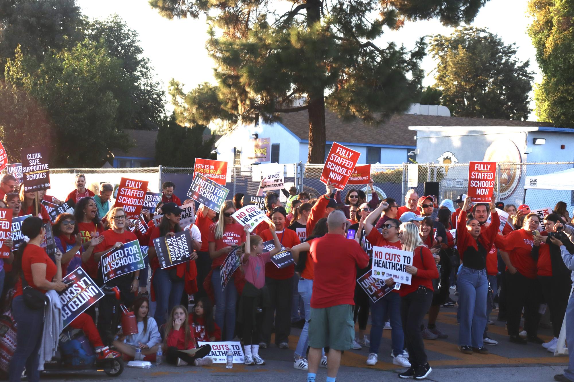 Los Angeles Unified School District (LAUSD) employees and families hold up signs to protest on Haynes St. at the LAUSD Local District Northwest rally on Nov. 6. The LAUSD Local District North West rally was one of five rallies throughout Los Angeles to spread awareness of LAUSD's contract demands concerning LAUSD employees' salary, staffing numbers and health care benefits. 
