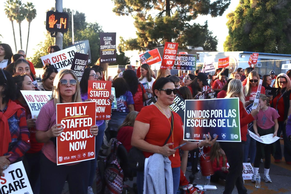 Los Angeles Unified School District (LAUSD) employees and families hold up signs on Haynes St. at the LAUSD Local District Northwest rally on Nov. 6. LAUSD employees and families protested throughout Los Angeles to hold LAUSD accountable for the expired contract with UTLA regarding LAUSD employees' salaries, staffing numbers throughout school campuses and health care benefits.
