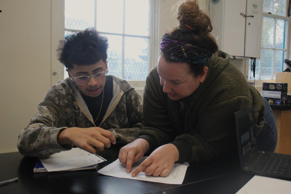 Sophomore Zeike Palacios receives help from long-term substitute teacher Courtney Carpenter during her period 1 chemistry on Jan. 23.
