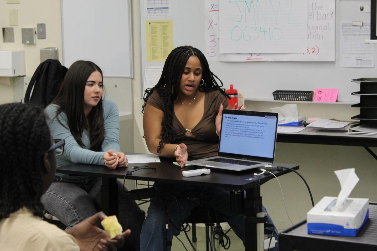Junior Isabella Tolosa and junior Jasmine Thompson present for Sharks 4 Christ club on Jan. 20.