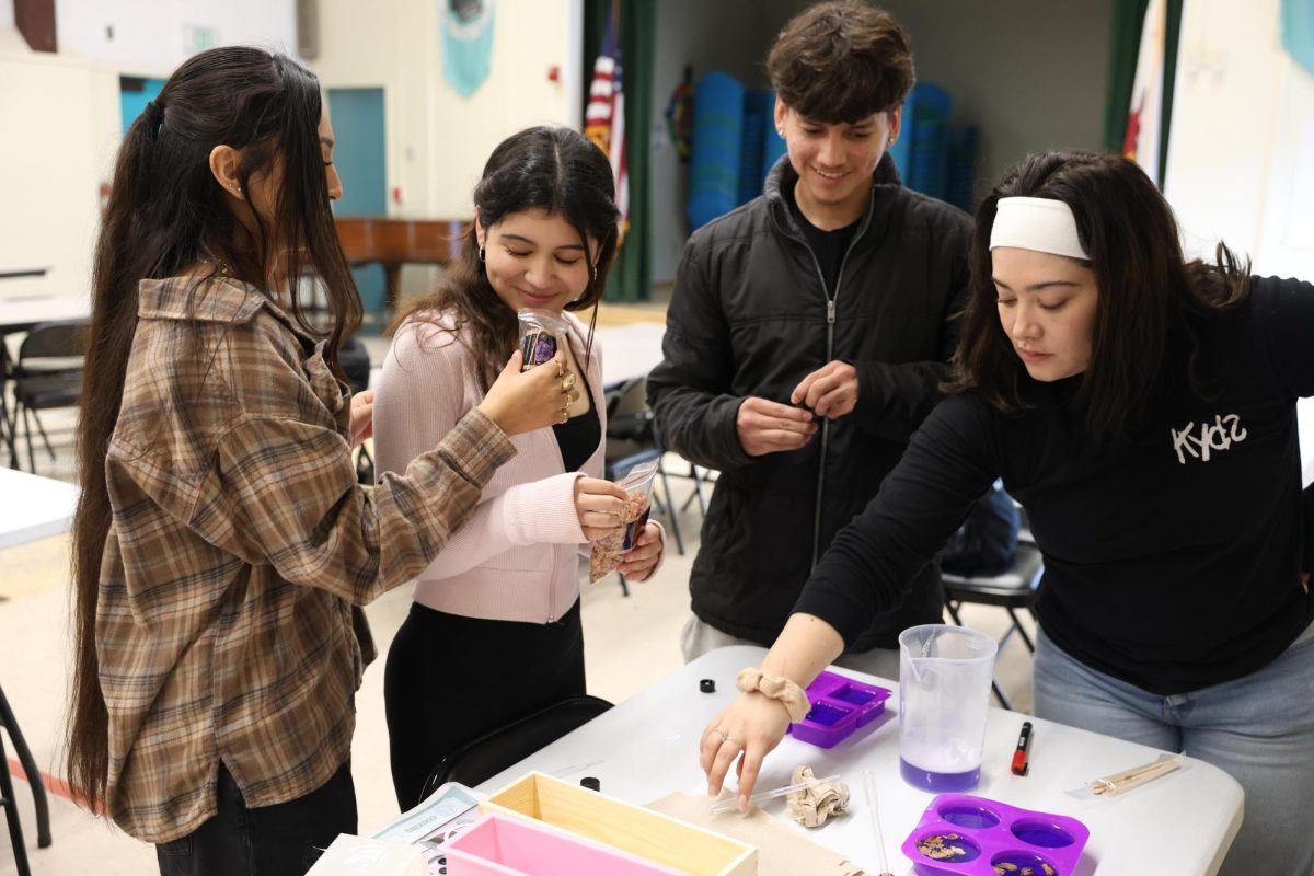 Seniors Guadalupe Martinez, Julia Garcia and Justin Pineda create candles with coach Andrea Rodriguez during the KYDS program’s self-care day on Nov. 13, 2025.