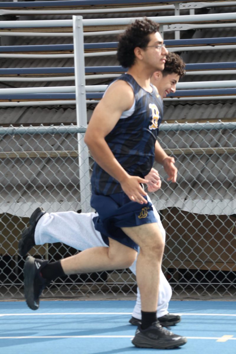 Sophomore Adrian Ayala Gomez sprints on the track at Birmingham Community Charter High School on Feb. 13.