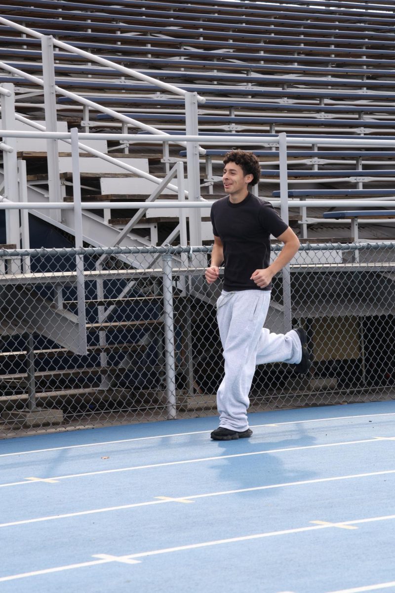 Sophomore Nathan Coello-Rodriguez runs on the track at Birmingham Community Charter High School on Feb. 13.