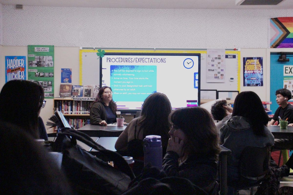 English Teacher Valerie Quiroga leads a volunteer meeting on March 3 for students interested in volunteering during Open House on March 13. 