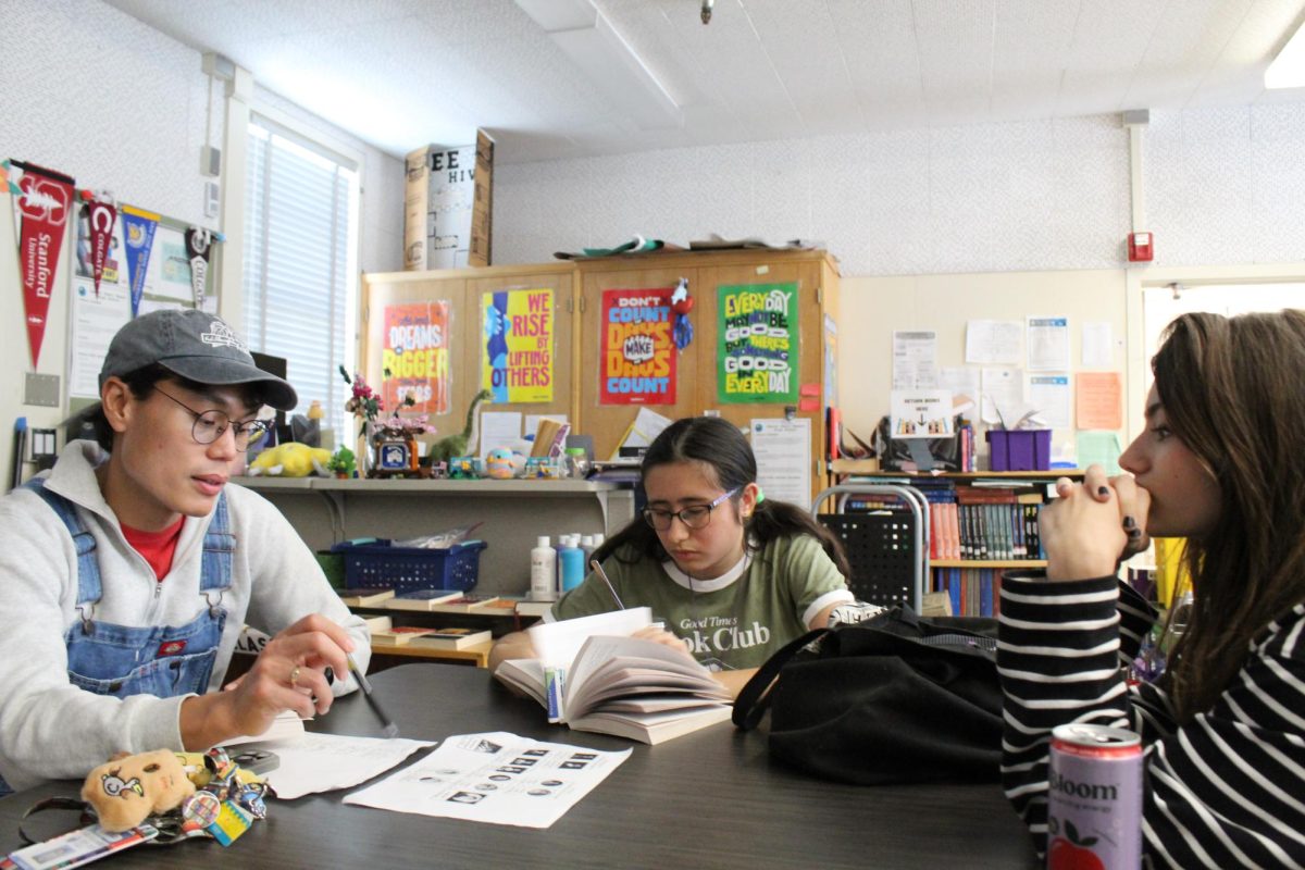 Librarian Alain Cruz, sophomore Camila Rodriguez and Book Club president Nadia Buer discuss how they felt while reading the novel "Wuthering Heights" by Emily Brontë on March 24.