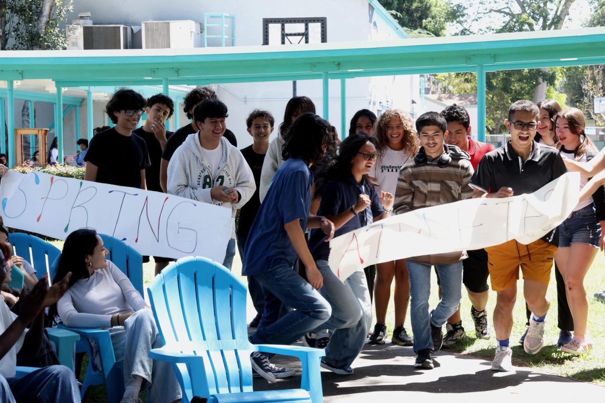 Spring athletes run through a banner during the final pep rally of the school year on April 23. 
