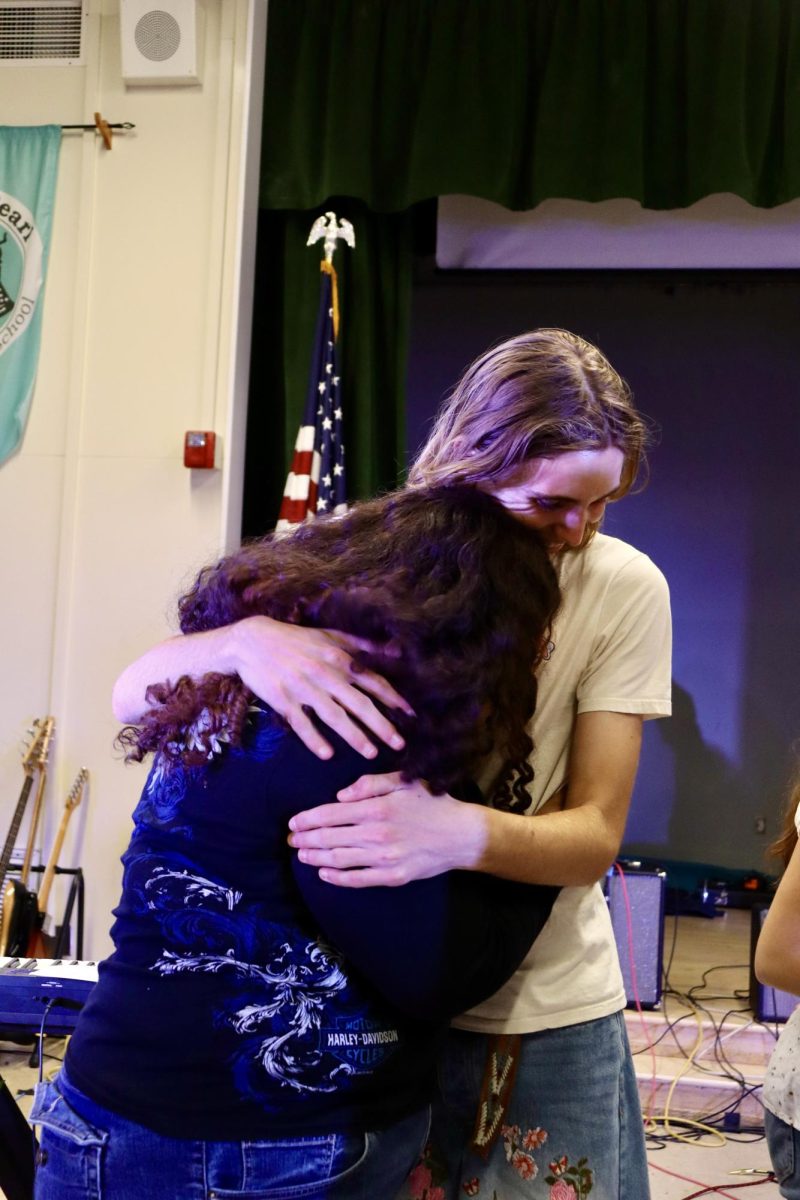 Senior Nemesi Morales and sophomore Jett Cabrinha embrace one another at the end of the Spring Concert on May 19.