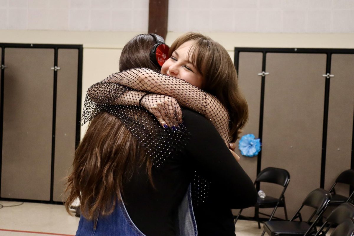 Junior Zarina Martirosyan and senior Serena Elkins embrace each other at the end of the Spring Concert on May 19.