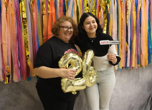 Office Technician Guadalupe Osorio and senior Marianna Alvarez Patino get ready to take a photo at the photo booth in the MPR during the senior commitment event on May 6.