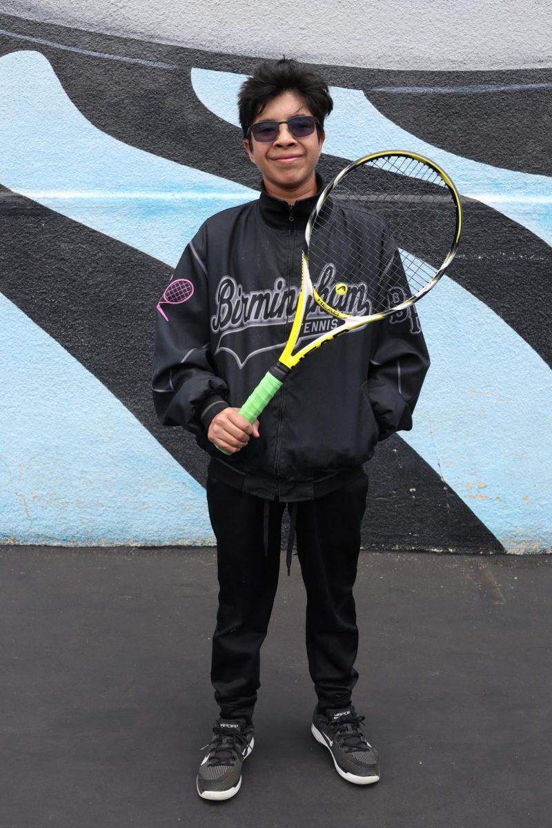 Junior Giancarlo Valdez holds his tennis racket on May 28. This is Valdez's third year on the Birmingham Community Charter High School Boys Tennis team. Additionally, this is his second year playing on the varsity team.