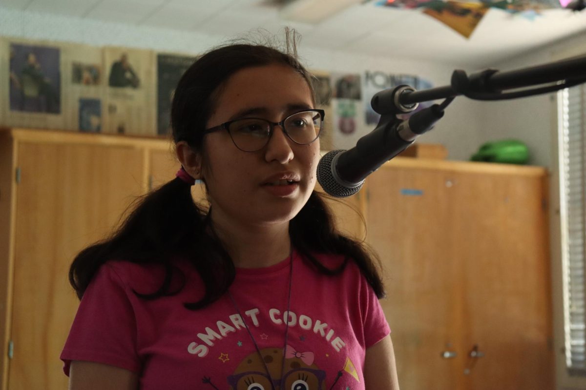 Sophomore Camila Rodriguez sings "Dark To Light" by Louis Tomlinson during lunch rehearsals for the Spring Concert in room 3 on May 15. 