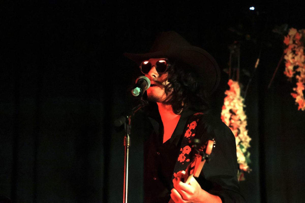 Junior Mateo Zazueta sings and plays guitar for “Too Many Puppies” by Primus during the Spring Concert on May 19. 