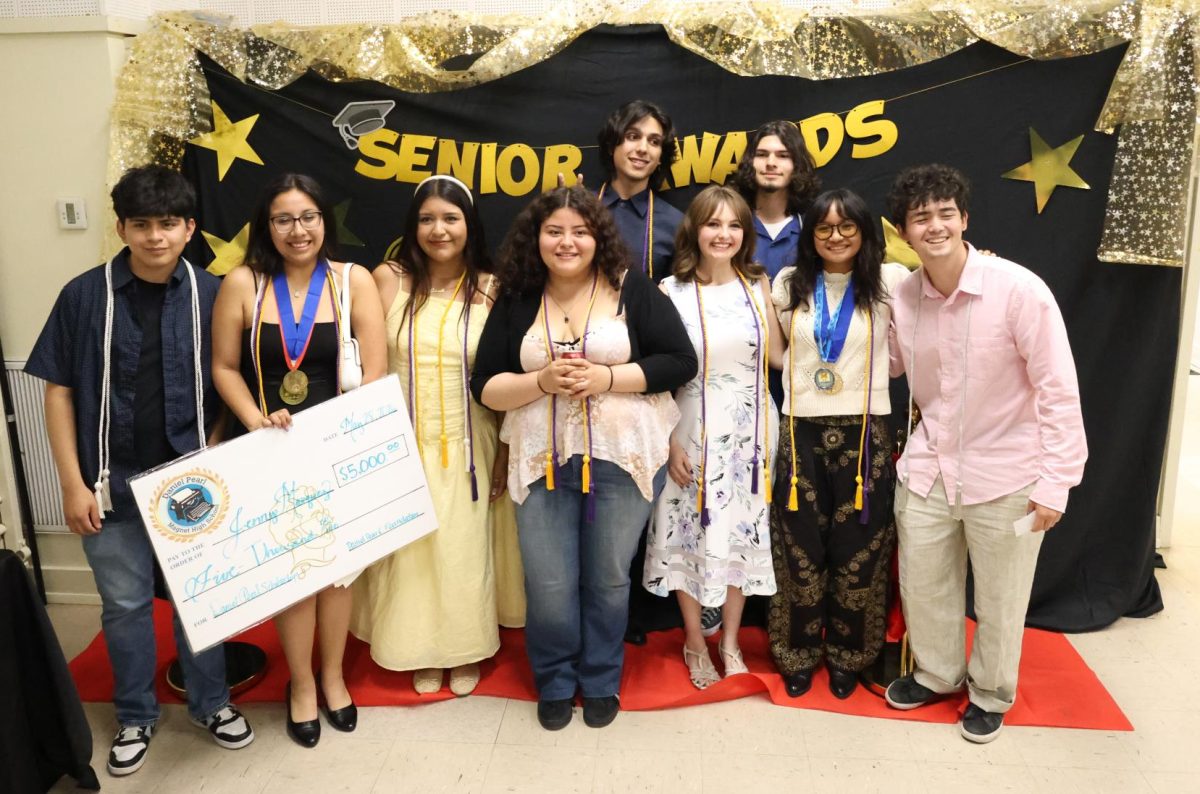 Seniors gather together to take a group picture at the end of Senior Awards Night on May 28.